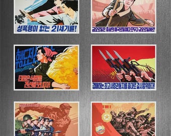 May include: A collection of eight vintage propaganda posters with Korean text and imagery. The posters feature illustrations of people, weapons, and slogans, with a color palette of red, yellow, and blue.