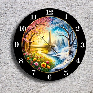 May include: A round wall clock with a black frame and a colorful landscape design. The clock face depicts a split scene: spring on the left and winter on the right. The clock hands are black, and the numbers are white.