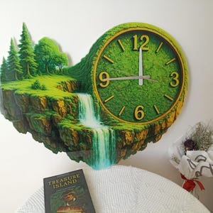 May include: A unique wall clock featuring a landscape design with a waterfall, trees, and a clock face. The clock has a green face with gold-colored numerals and hands. The clock is mounted on a white wall.