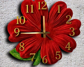 May include: A red flower-shaped wall clock with gold-colored numerals and hands. The clock has a textured, velvet-like appearance and a green leaf accent. The numbers are in a classic font.