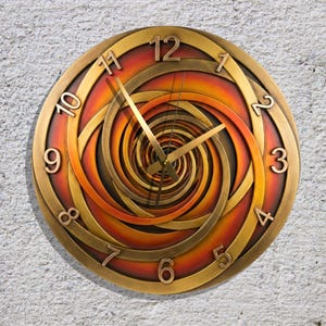May include: A round wall clock with a spiral design. The clock face features a gradient of orange and red hues, with gold-colored hands and numerals. The clock's outer frame and numerals are also gold-colored.