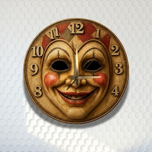 May include: A round wall clock featuring a central face mask with a wide smile, red cheeks, and dark eye sockets. The clock face has a beige background with a red and brown diamond pattern at the top, and gold-colored numbers from 1 to 12.