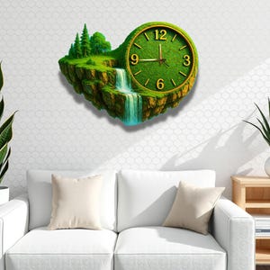 May include: A unique wall clock featuring a landscape design. The clock face is green, with gold-colored numerals and hands. The clock's design includes a waterfall, trees, and a grassy area, creating a nature-inspired aesthetic. The clock is mounted on a white wall.
