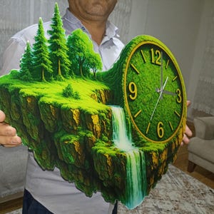 May include: A unique wall clock featuring a landscape design with a waterfall and trees. The clock face is green with gold numerals. The clock is approximately 18 inches wide and 15 inches tall.