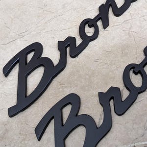 Bronco Script Badge Emblem in Metal Mate Black for left and right fender pair