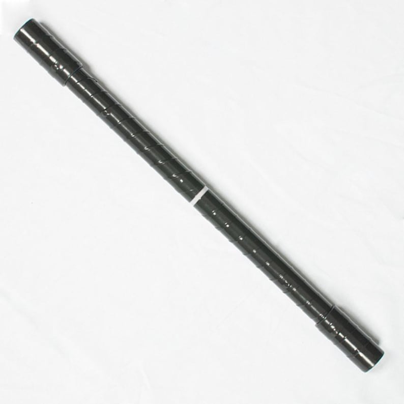 May include: A black metal shelf pole with a white band in the middle. The pole is cylindrical and has a series of horizontal grooves along its length. The ends of the pole are capped with a darker metal.