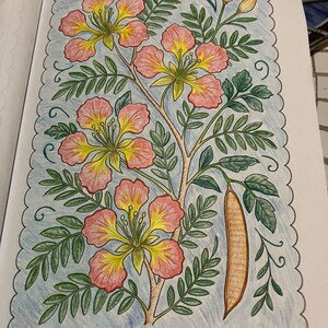 May include: A detailed coloring book page featuring a floral illustration. The image showcases pink and yellow flowers with green leaves and a brown seed pod. The artwork is framed by a light blue border with a scalloped edge.