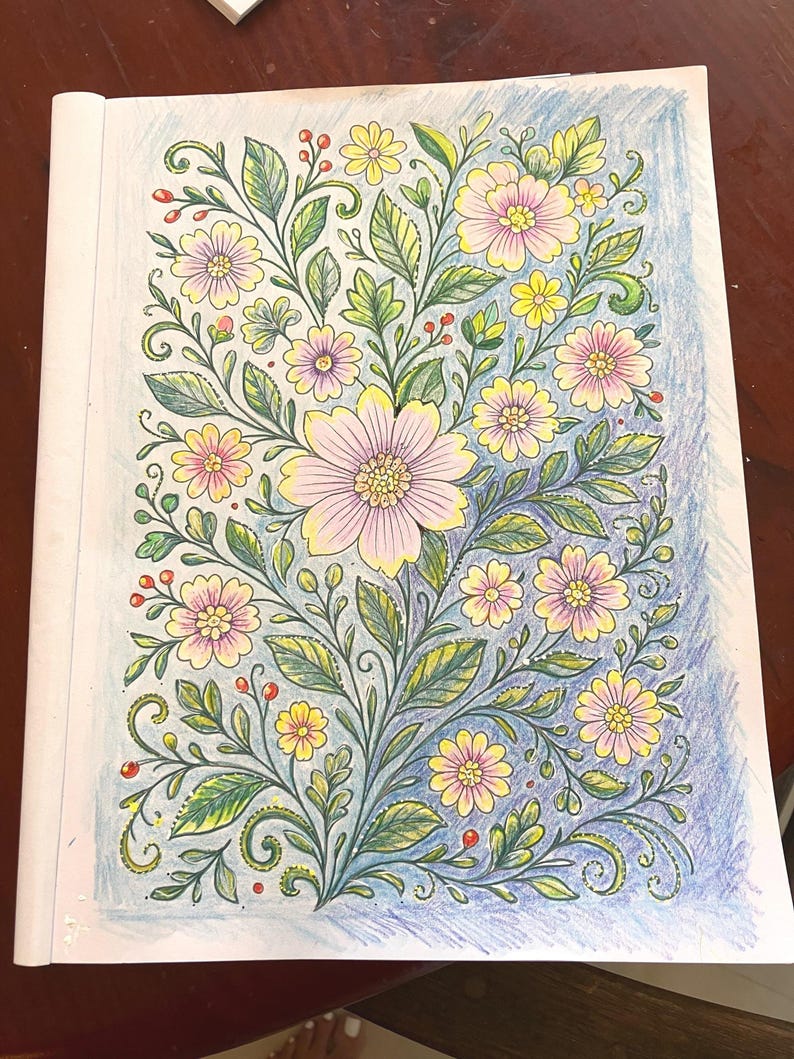 May include: A floral coloring page featuring a detailed botanical design. The illustration showcases a variety of flowers in shades of pink and yellow, with green leaves and stems. The background is shaded in blue.