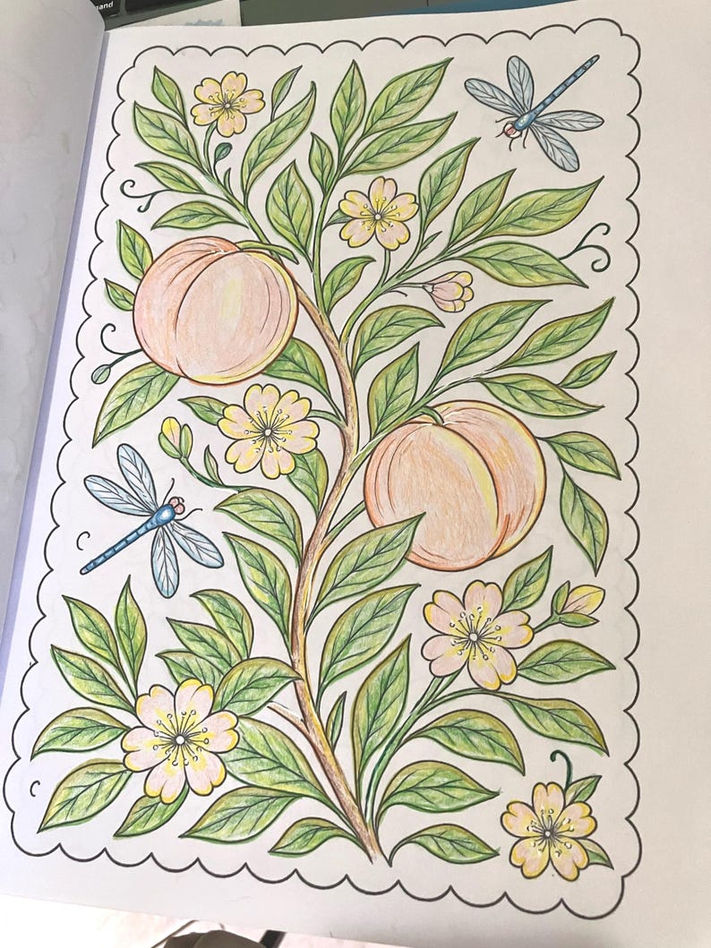 May include: A detailed coloring page featuring a peach tree with two large peaches, green leaves, and delicate yellow flowers. Two blue dragonflies are also included in the design. The image is framed with a scalloped border.