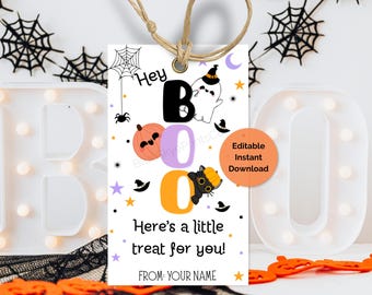 May include: A white Halloween gift tag with the word "Boo" in black, purple, and orange. The tag features a ghost, pumpkin, and black cat graphic. Text on the tag reads "Here's a little treat for you!" and "FROM: YOUR NAME".