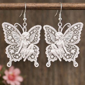 May include: A set of three ceramic mugs with a speckled, matte finish in cream, light grey, and dark grey. Each mug has a minimalist design and a rounded handle. The mugs are stacked on top of each other.