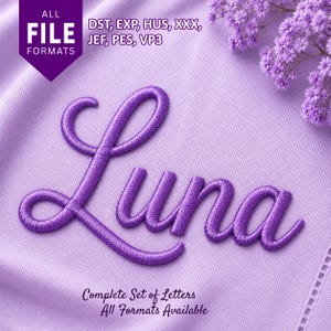 May include: A purple embroidered script font spelling the name Luna on a light purple fabric background. The image includes text stating ALL FILE FORMATS and lists DST, EXP, HUS, XXX, JEF, PES, VP3, along with the text Complete Set of Letters.