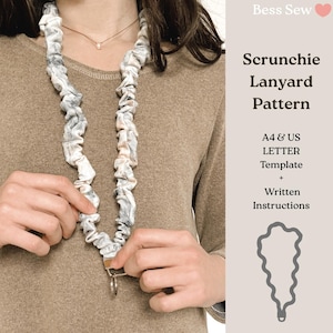 Puede incluir: Se muestra un patrón de cordón scrunchie, con un cordón de tela con un diseño veteado gris y blanco. El cordón lo sostiene una persona que lleva una camiseta marrón. El texto de la derecha dice "Scrunchie Lanyard Pattern" e incluye "A4 & US LETTER Template + Written Instructions."
