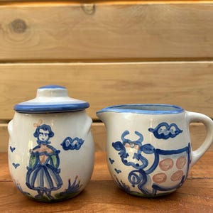 M.A. Hadley Creamer and Lidded Sugar Bowl Set with "Farmer's Wife and Cow" Design