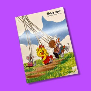 May include: A vintage "Suzy's Zoo" coloring book, Vol. 19, featuring cartoon characters on swings. The cover shows a mouse, a chick, and a bear enjoying a sunny day. The background includes a blue sky and green grass.