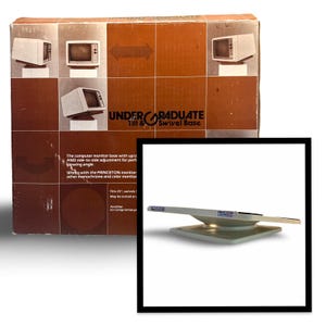 May include: A vintage computer monitor base with the text "UNDERGRADUATE Tilt & Swivel Base" on the box. The base is light gray and has a rectangular base with a swivel arm. The box shows images of old computer monitors.