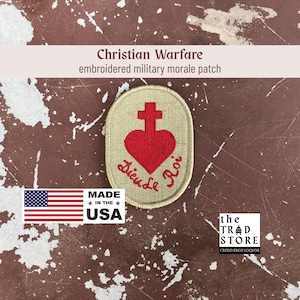 May include: Embroidered military morale patch with a red heart and cross design, and the words "Dieuse Roi". The patch is tan with a stitched border. The text "Christian Warfare" is above the patch. Made in the USA.