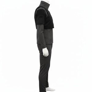 May include: A black outfit comprising a mock turtleneck long-sleeved top, a cropped vest, and matching trousers. The vest features a square design on the shoulders. The outfit is displayed on a mannequin against a white backdrop.