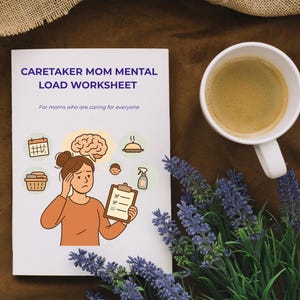 May include: A white worksheet titled "Caretaker Mom Mental Load Worksheet" with an illustration of a woman holding a clipboard. A cup of coffee and lavender sprigs are next to the worksheet on a brown surface.