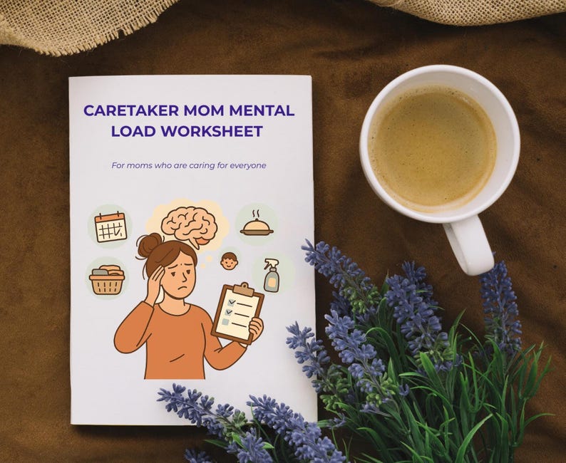 May include: A white worksheet titled "Caretaker Mom Mental Load Worksheet" with an illustration of a woman holding a clipboard. A cup of coffee and lavender sprigs are next to the worksheet on a brown surface.