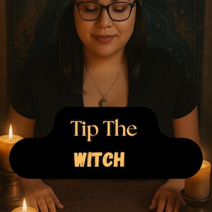 May include: A person with glasses and a headband sits before tarot cards, with lit candles on either side. A black cloud-shaped graphic displays the text "Tip The Witch". The cards are laid out on a brown surface.