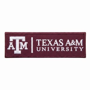 May include: A rectangular embroidered patch featuring a maroon background with white stitching. On the left is the Texas A&M University logo, and on the right is the text "TEXAS A&M UNIVERSITY" in a white serif font, separated by a vertical line.