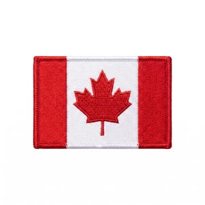 May include: A rectangular embroidered patch featuring the Canadian flag design. The patch has a white central square with a red maple leaf in the middle, flanked by two solid red vertical rectangular sections on the left and right sides.