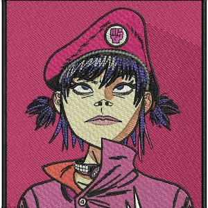 May include: Embroidered patch featuring a stylized portrait of a character with purple hair, wearing a pink beret with a fist emblem and a pink jacket. The patch has a black border and is set against a pink background.