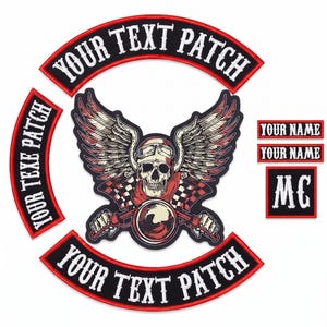May include: A set of embroidered patches featuring a central skull wearing goggles with wings and crossed checkered flags. Includes three curved rocker patches with the text YOUR TEXT PATCH, two rectangular name patches, and one square MC patch.