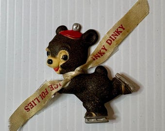 Vintage ICE FOLLIES "Inky Dinky" ice-skating bear souvenir pin.