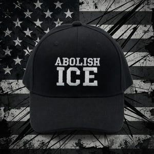 May include: Black baseball cap with the text "ABOLISH ICE" in white block letters. The cap is set against a distressed American flag background, with a grunge effect.