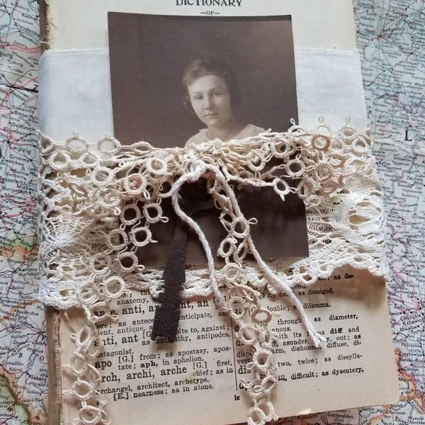 Romantic upcycled book stack with vintage lace old rusty key and old photograph