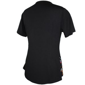 May include: Black short-sleeved shirt with a colorful design on the right side of the shirt.