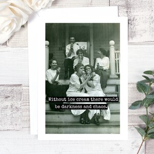 May include: A black and white photograph of a group of people sitting on a porch, eating ice cream. The caption reads "Without ice cream there would be darkness and chaos."