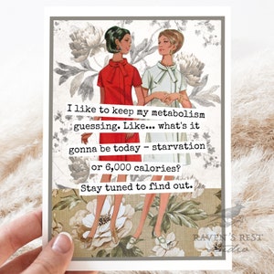 May include: A greeting card featuring two women in vintage dresses. The card has a floral background and text that reads, "I like to keep my metabolism guessing. Like... what's it gonna be today - starvation or 6,000 calories? Stay tuned to find out."