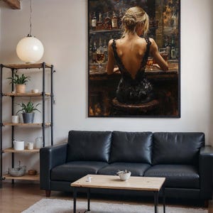 May include: A framed painting depicts a woman at a bar, wearing a black dress. The painting hangs above a black leather sofa, with a wooden coffee table and a fluffy rug. A metal and wood shelf holds plants and decorative items. A large white globe light hangs from the ceiling.