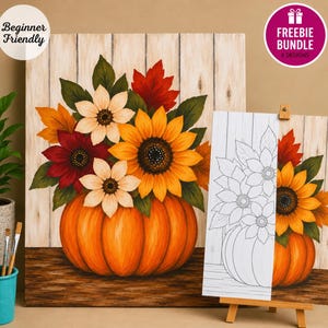 May include: A painting of a large orange pumpkin filled with sunflowers and autumn leaves against a light wood background. A partial black and white line art version of the same image is displayed on a wooden easel next to the finished painting.