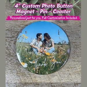May include: A circular 4-inch custom photo button, magnet, pin, or coaster featuring a printed image of two people sitting in a field of wildflowers under a clear blue sky. The text Thank You is printed in white script at the bottom of the image.