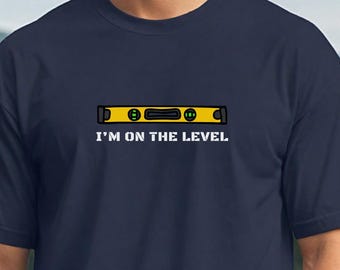 I'm On The Level: Funny saying with the graphic of a carpenter level in a Unisex Softstyle T-Shirt