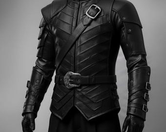 May include: Black leather jacket with a high collar, shoulder pads, and intricate stitching. Features a belt with a decorative buckle and multiple buckles on the sleeves. The jacket has a unique, textured design and a diagonal strap.