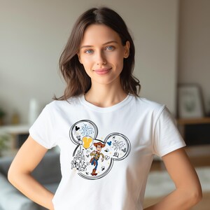 A woman wearing a white t-shirt with a Mickey Mouse design and a character from the Toy Story franchise.