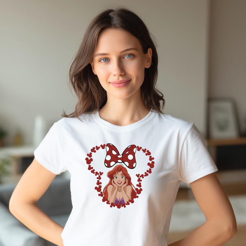 A woman wearing a white t-shirt with a cartoon character and a bow on it.