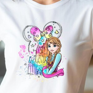 A young woman wearing a white t-shirt with a colorful graphic of a cartoon character.