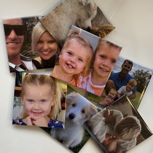 May include: A collection of square photo tiles featuring various family portraits and a dog. The images include smiling faces of adults, children, and a fluffy white and tan puppy. The tiles are arranged in a slightly overlapping pattern.