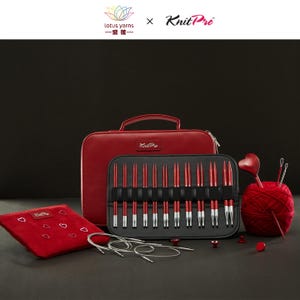 May include: A red leather knitting needle set with accessories. The set includes a zippered case, a black case with red and silver knitting needles, a red pouch with heart accents, and a ball of red yarn with knitting needles.
