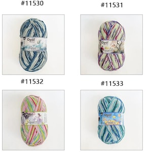 May include: A collection of eight skeins of Opal Aquarell yarn in various color combinations. Each skein is labeled with a unique number and features a colorful, variegated pattern. The yarn is wrapped with a label that includes the brand name and product details.