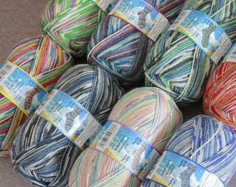 May include: A collection of colorful yarn skeins, each with a label. The yarn displays a variety of colors, including blues, greens, pinks, and oranges. The labels have text and a graphic of a sock. Ideal for knitting and crochet projects.
