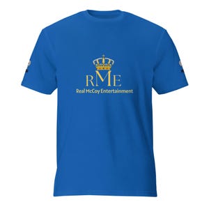 May include: Royal blue t-shirt with a gold crown logo above the letters "RME" and the words "Real McCoy Entertainment" in gold. The shirt is a solid color with a crew neck.