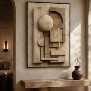 Può includere: Un'opera d'arte murale rettangolare caratterizzata da una composizione tridimensionale di forme geometriche, tra cui cerchi, rettangoli e quadrati in varie tonalità di beige, sabbia e marrone, racchiusa in una sottile cornice nera.