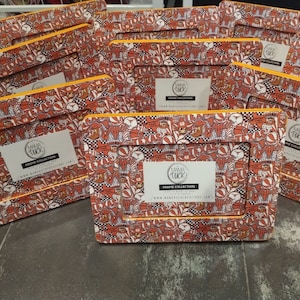 May include: A collection of rectangular picture frames with a repeating pattern in orange, white, and black. The frames have a yellow border and a label that reads "Mama Duck Frame Collection".